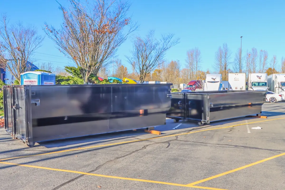 Professional dumpster rental service with roll-off container on residential driveway in Great Bend